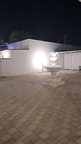 a bird cage sitting in a courtyard at night at dimora relax MICHELA in Galatina