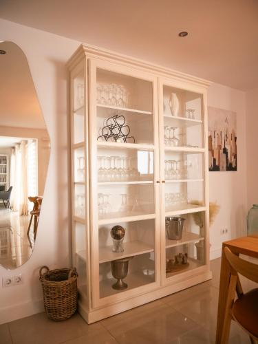 a white cabinet with glass doors in a room at El Pirata 78 in Estepona
