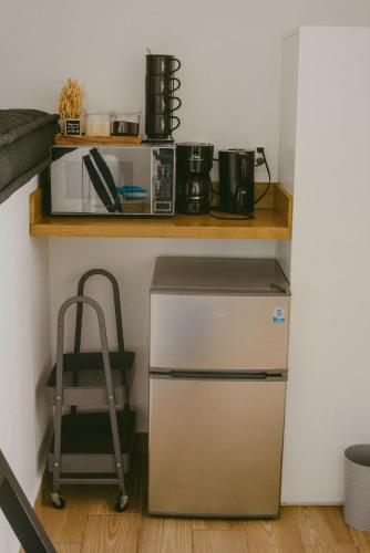 a small kitchen with a shelf and a refrigerator at BeachView & Balcony 3905 in Cancún