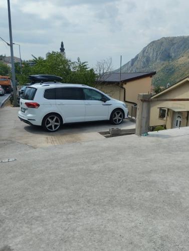 a white van parked in a parking lot at Guesthouse Panorama in Mostar