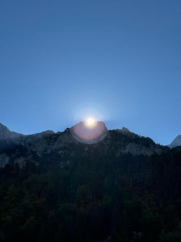 a sun setting on top of a mountain at Guesthouse Drinos Valbone in Valbonë