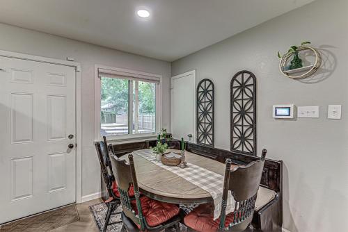 a dining room with a table and chairs and a window at Dulwich Drift - Cowboy Pool Fire Pit & Chill Backyard Vibes in Austin