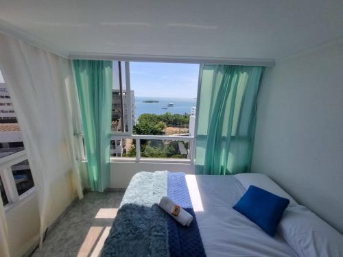 a bedroom with a bed and a large window at Bahía Fragata 803A in San Andrés
