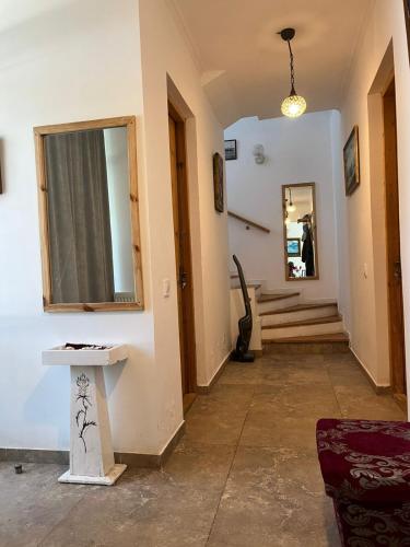 a hallway with a mirror and a table and stairs at OK Sakhli VIP in Shekvetili