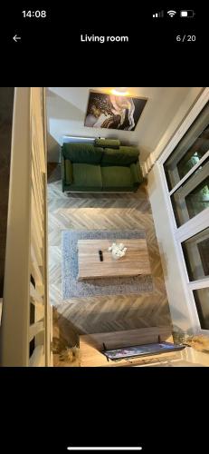 a living room with a green couch and a table at Central City Apartment in Central Station