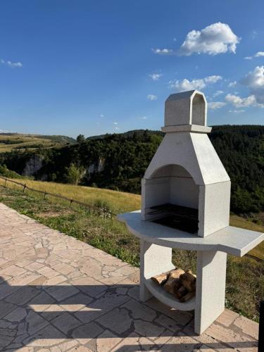 a stone pizza oven sitting on the side of a road at Vikendice Moskva Uvac in Sjenica