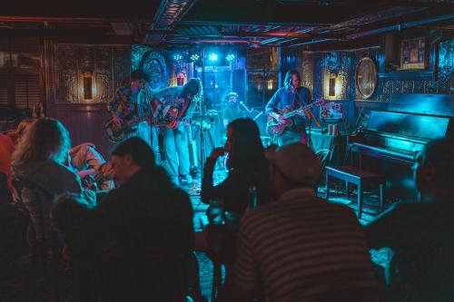 a group of people watching a band on a stage at The Red Lion Inn in Stockbridge