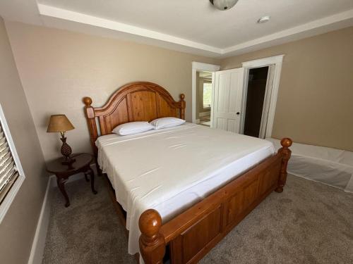 a bedroom with a large wooden bed in a room at Best Deal-8 beds- Perfect for large Team in Willmar
