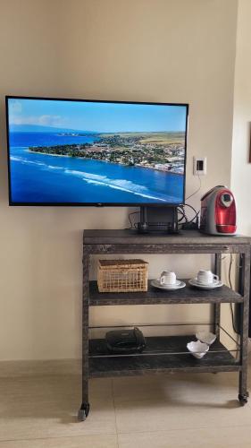 a flat screen tv hanging on a wall at Casa Loft 9C in São Luís