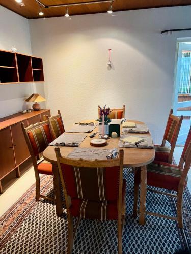 a dining room with a wooden table and chairs at Sunrise Haven in Rødby