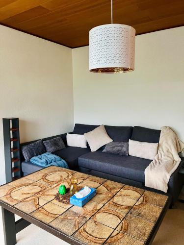 a living room with a couch and a table at Sunrise Haven in Rødby