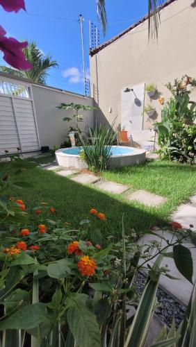 a garden with orange flowers in the grass at Casa Loft 9C in São Luís