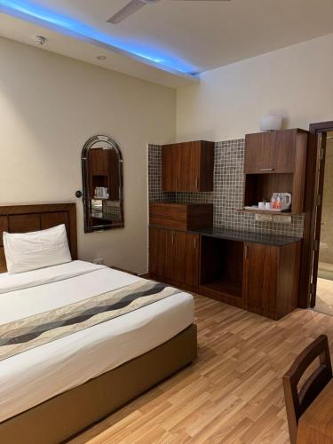 a bedroom with a large bed and wooden cabinets at UDS Villa - Next to VFS, Walking to Connaught Place in New Delhi