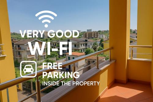 a sign that reads very good wifi free parking inside a balcony at Iliria Durres Apartments in Durrës