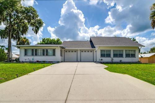 a white house with a large driveway at Explore Dtwn Crystal River Walkable Duplex Unit in Crystal River