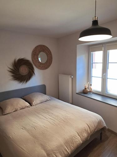 a bedroom with a large bed and a window at Emile&Jeanne - Centre - 2 chambres - Wifi, Netflix in Wissembourg