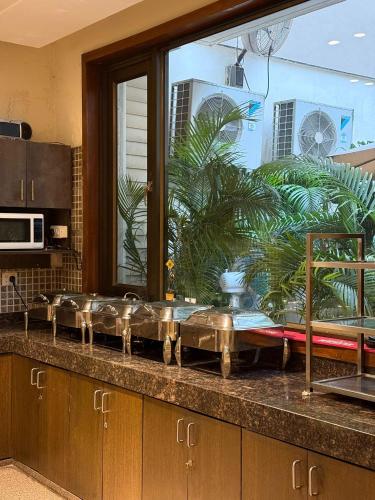 a kitchen counter with a sink in a kitchen at UDS Villa - Next to VFS, Walking to Connaught Place in New Delhi
