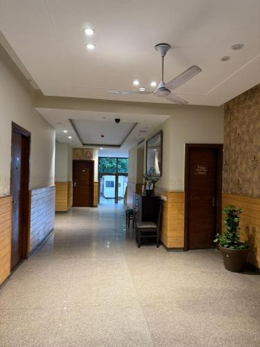 an office lobby with a ceiling fan and a chair at UDS Villa - Next to VFS, Walking to Connaught Place in New Delhi