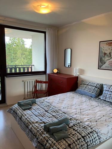 a bedroom with a large bed and a window at Borovets Gardens apartment C-43 in Borovets