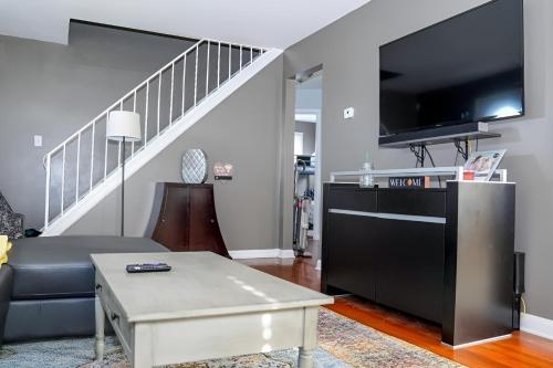a living room with a couch and a flat screen tv at Spacious 4BR Family & Work-Friendly Home, Close to Airport in Columbus
