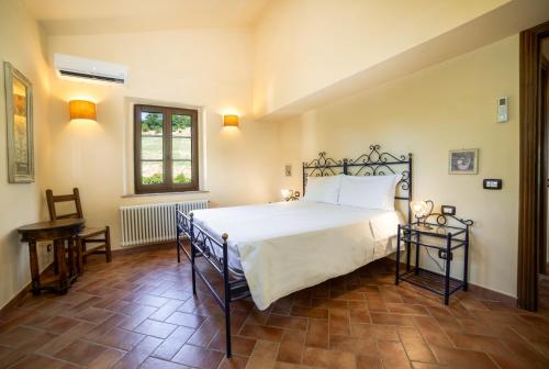 a bedroom with a large bed in a room at Scappo in Umbria, La dolce Godera in Lugnano in Teverina