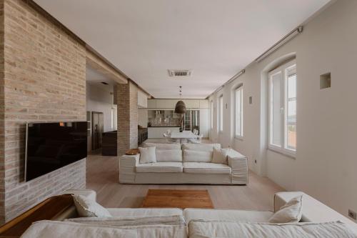 a living room with a couch and a fireplace at Apartments Argemonia in Mali Lošinj