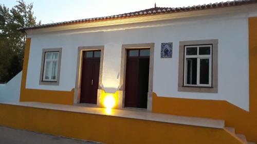 a small house with a light in the window at Casa dos Aleluia in Coimbra