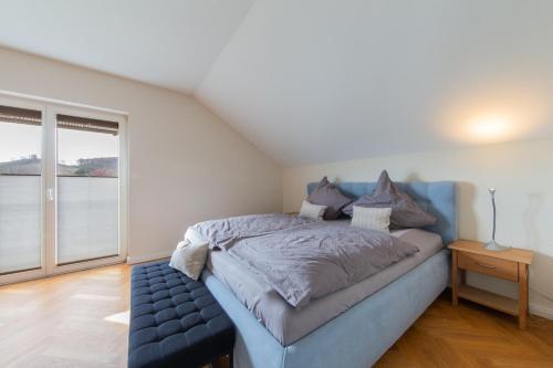 a bedroom with a bed and a large window at Gemütliche Ferienwohnung direkt am Wald in Arnsberg