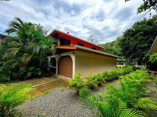 a house with a red roof and a garage at Casa Iguana in Puerto Viejo