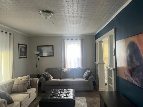 a living room with a couch and a table at Home In Highland Park in Saint Paul