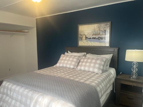 a bedroom with a bed with a blue wall at Home In Highland Park in Saint Paul
