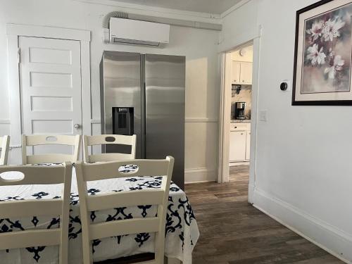 a kitchen with two chairs and a white door at Home In Highland Park in Saint Paul