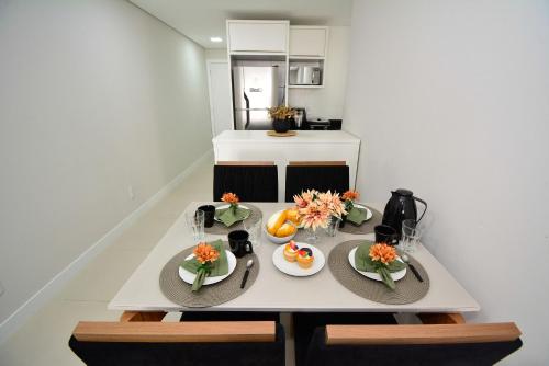 a table with plates of food on it in a kitchen at Apartamento Aconchegante em Itajaí - ITJ001 in Itajaí