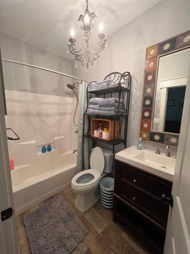 a bathroom with a toilet and a sink and a chandelier at Morning Glory in Longview