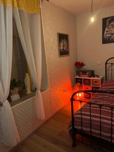 a bedroom with a bed with a red light in it at Chambre in Vigneulles-lès-Hattonchâtel