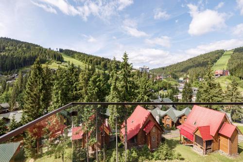 an aerial view of a village with houses and trees at Tavel Hotel & SPA in Bukovel