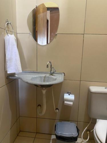 a bathroom with a sink and a toilet at Casa em Praia de Flecheiras in Trairi