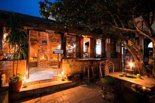 a patio with a bar at night with lights at Peace Eye Guest House in Pokhara
