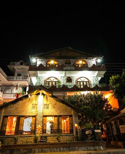 a large building with lights on it at night at Peace Eye Guest House in Pokhara