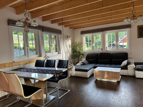 a living room with a couch and a table at Anielski Domek in Nieledwia