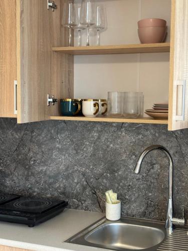 a kitchen with a sink and a counter top at Self Check- in Cozy Apartment in Cēsis