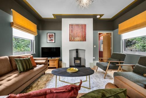a living room with a couch and a table at The Old Station in Cambridgeshire in Stow cum Quy