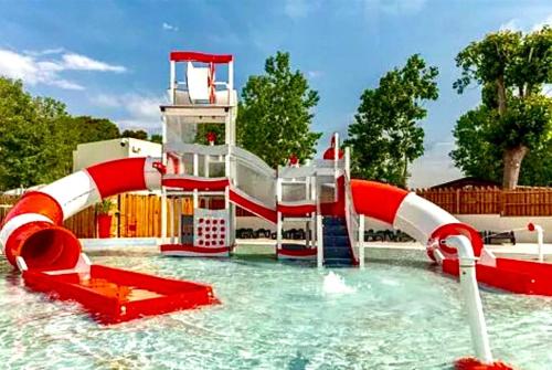 a water park with a water slide in a pool at Mobil-home domaine la yole 5 étoiles in Vendres