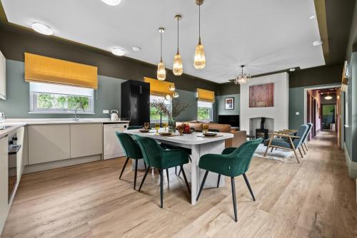 a kitchen and dining room with a table and chairs at The Old Station in Cambridgeshire in Stow cum Quy