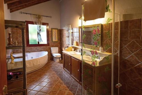 a bathroom with a tub and a sink and a toilet at VILLA NABRISA MARBELLA, 5 BEDROOM, PRIVATE POOL, GARDEN, BBQ in Marbella