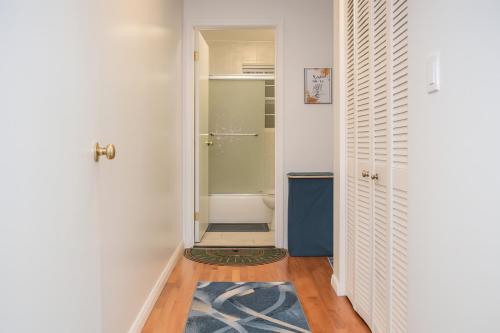 a bathroom with a walk in shower next to a door at 3BR & 2Bath Bronx Stay-Private Suite-Parking in Bronx