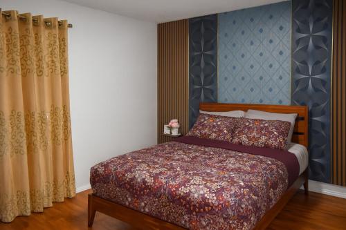a bedroom with a bed and a blue wall at 3BR & 2Bath Bronx Stay-Private Suite-Parking in Bronx