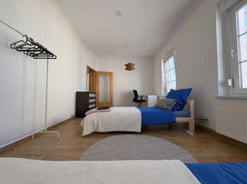 a bedroom with a bed and a chair in it at Entire house with garden - exclusively for your group in Leipzig