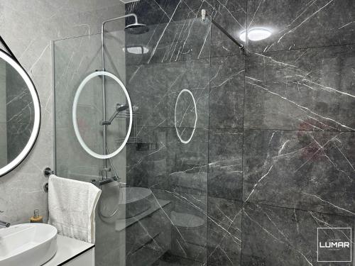 a bathroom with a shower with a glass door at Apartment Lumar in Ljubuški