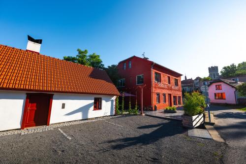 a group of buildings in a parking lot at Pension Merano in Jetřichovice